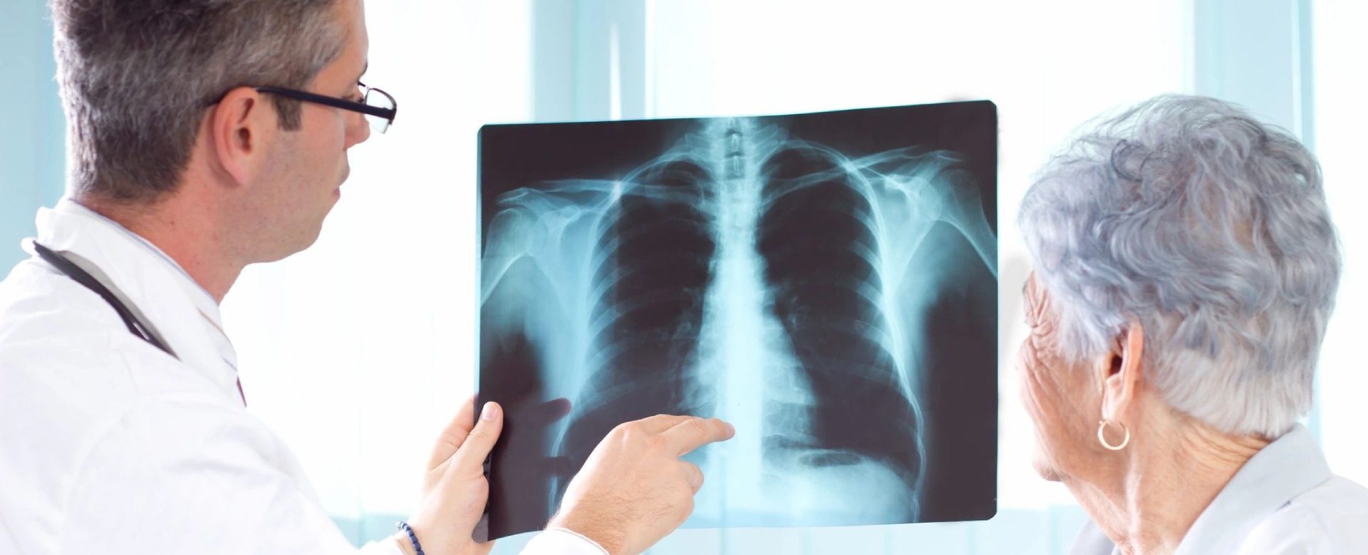 A person points to an x-ray of their chest.